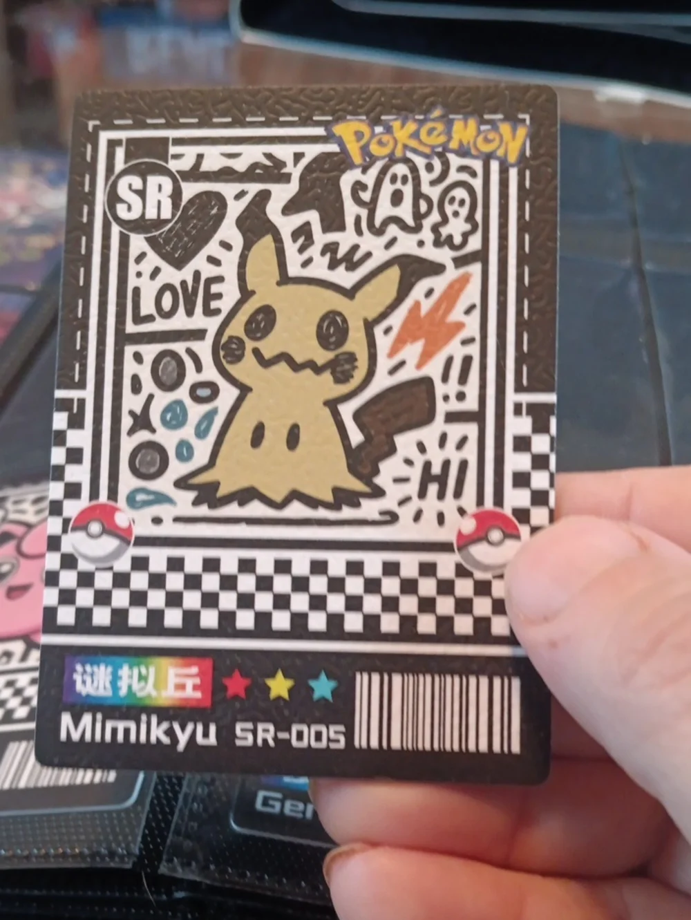 Pokemon Mimikyu Trading Card — black, yellow, orange, blue